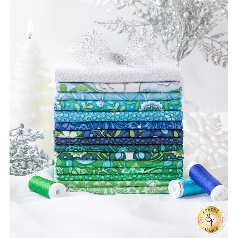 A stack of winter Christmas fabrics from the Peace On Earth 15 FQ Set.