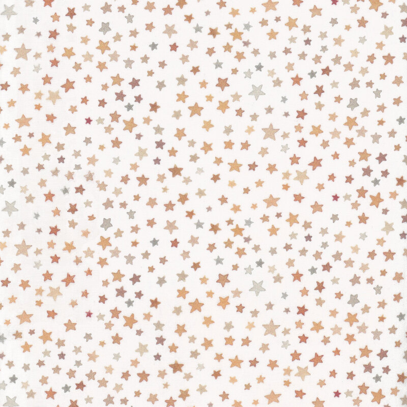 white fabric with small stars all over in shades of brown and yellow