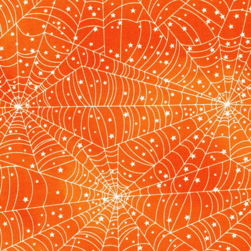 scan of fabric with glowing white spider web pattern and tossed ditzy stars on a bright orange background