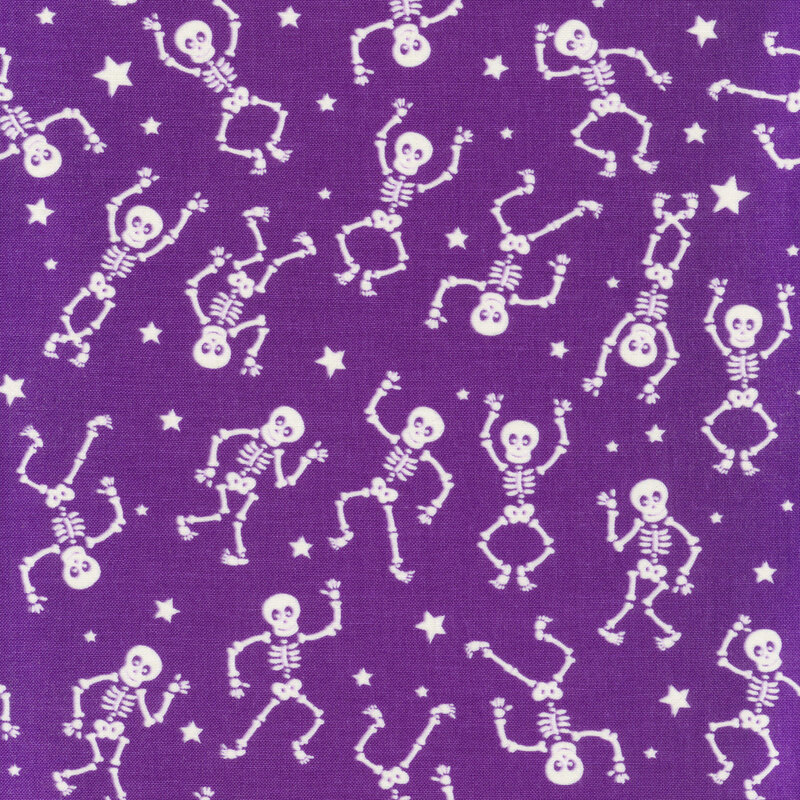 scan of fabric with white dancing skeletons and tossed stars on a purple background