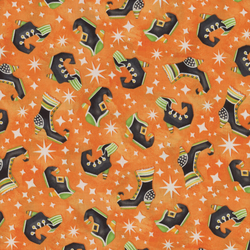 Bright orange Halloween fabric with tossed witches shoes and stars all over