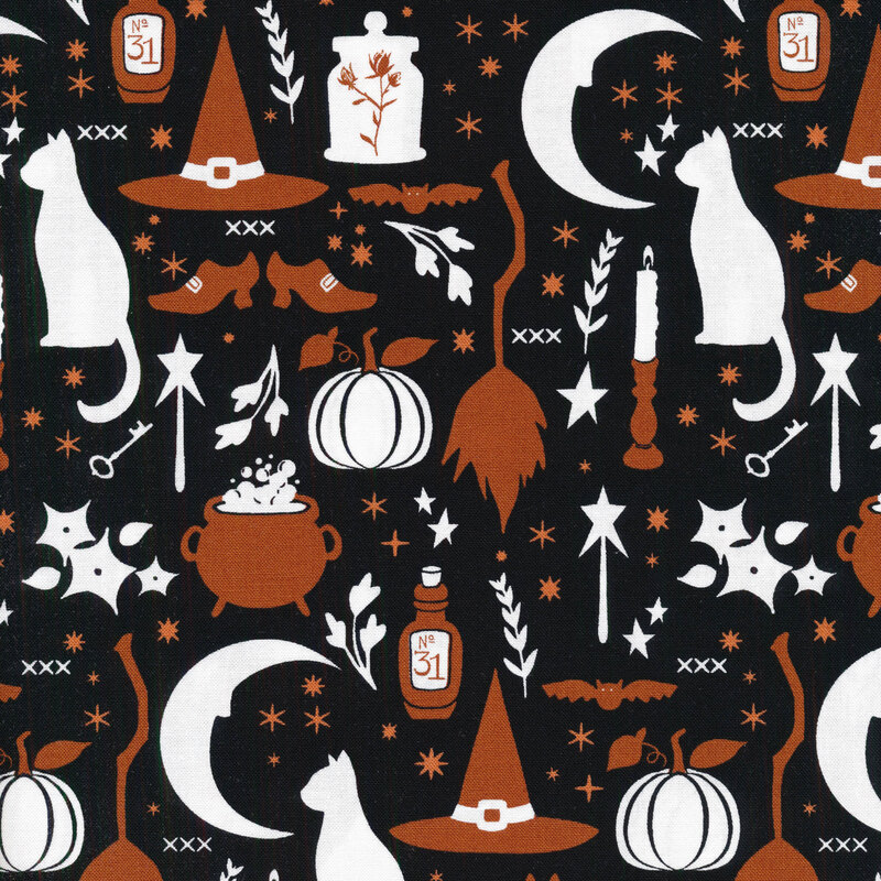 Black fabric with silhouettes in white and orange of Halloween motifs like cats, candlesticks, brooms, a crescent moon, crystal ball, etc.