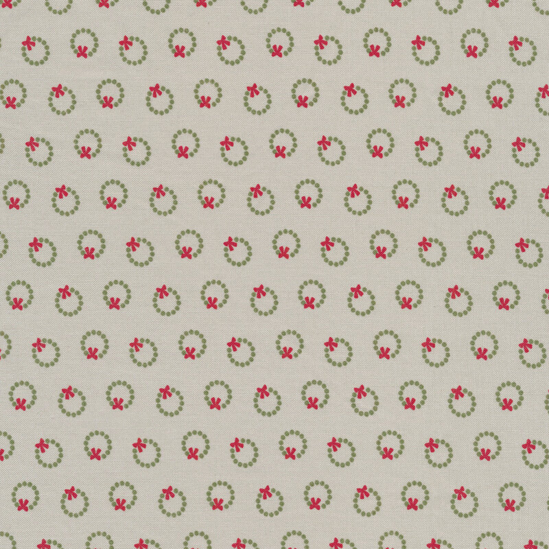 fabric featuring ditzy green christmas wreaths on a gray background