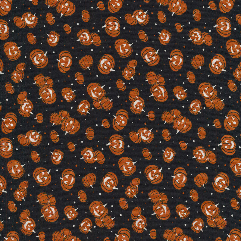 Black fabric with tossed orange jack o lanterns and small orange and white dots