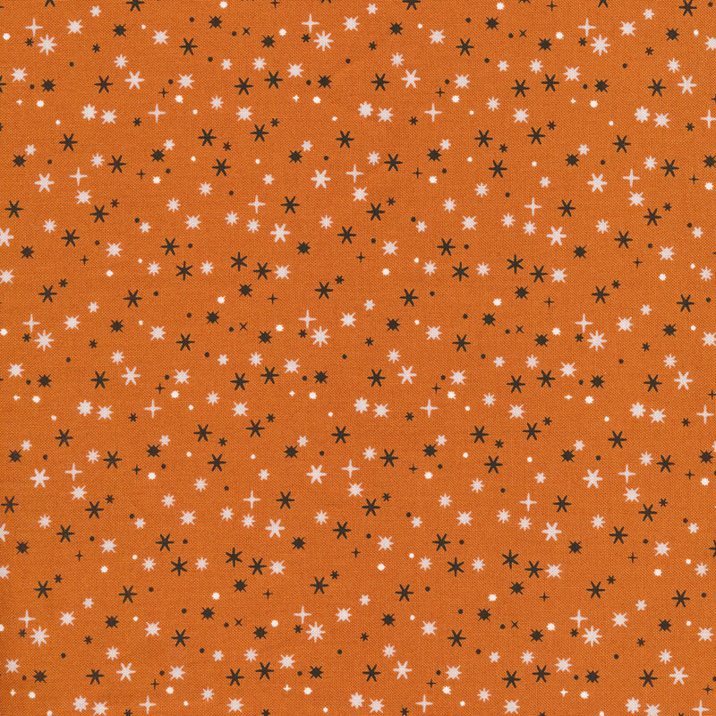 Orange fabric with Black and white stars with varying points scattered all over