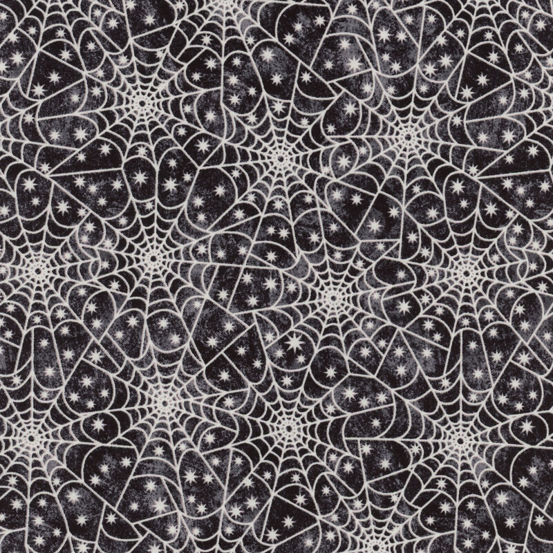 Black fabric with white spiderwebs and stars