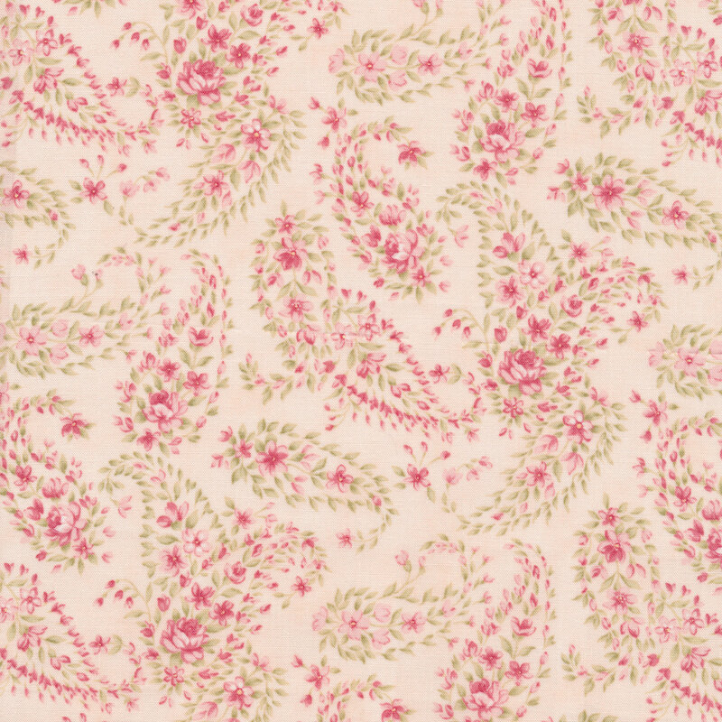 Cream fabric with a paisley pattern made up of pink flowers and green leaves