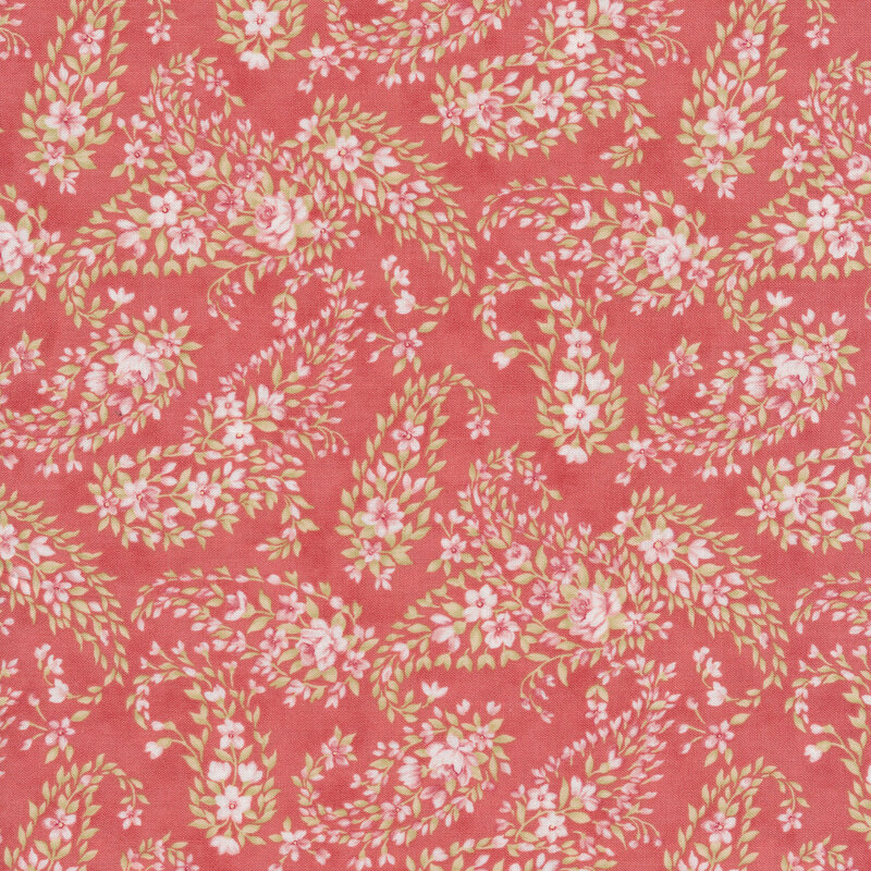 Pink fabric with a paisley pattern made up of pink and white flowers and green leaves