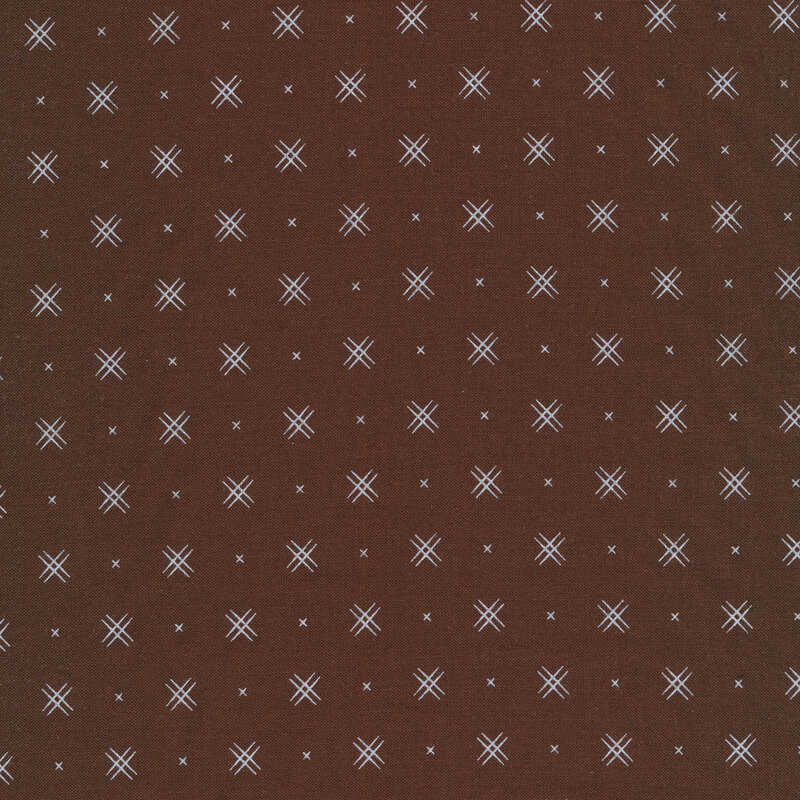 Brown fabric with rows of small white x's and double criss-cross patterns