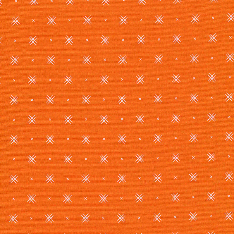 Orange fabric with rows of small white x's and double criss-cross patterns