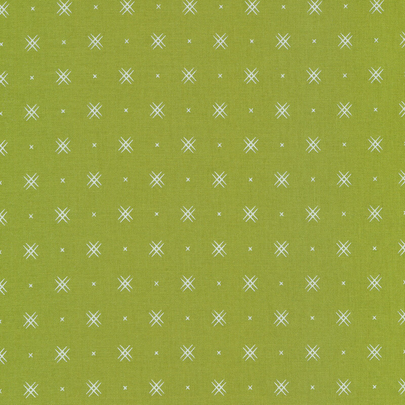 Green fabric with rows of small white x's and double criss-cross patterns