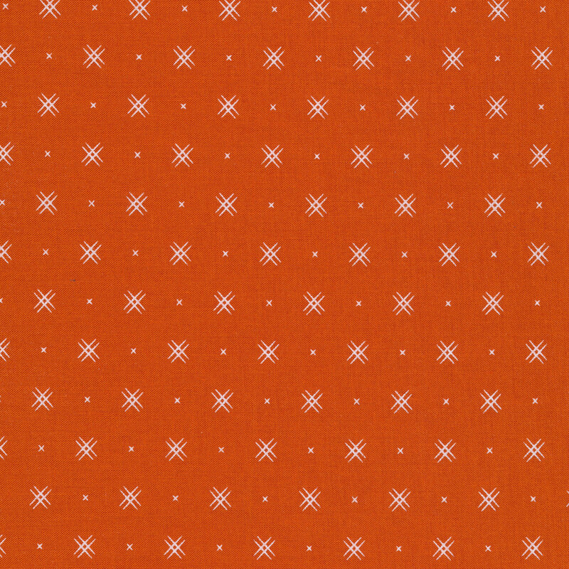 Dark Orange fabric with rows of small white x's and double criss-cross patterns