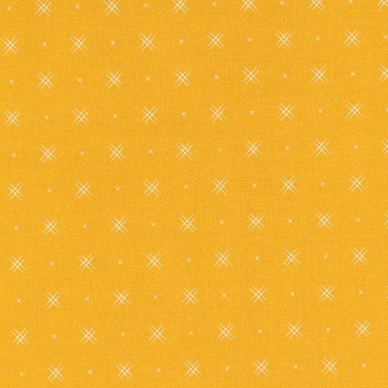 Yellow fabric with rows of small white x's and double criss-cross patterns