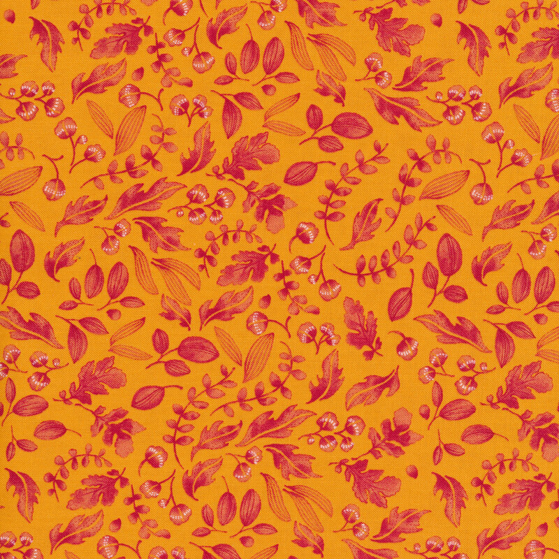Golden orange fabric with reddish-pink leaves and sprigs all over