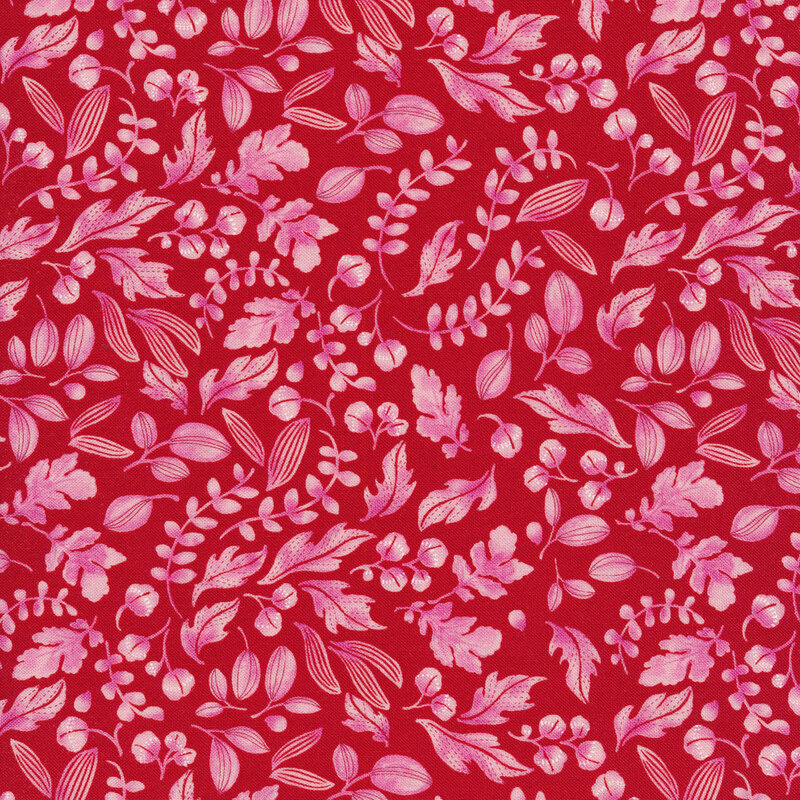 Raspberry red fabric with light pink leaves and sprigs all over