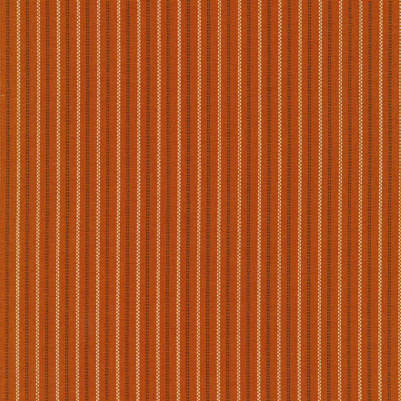 cream and black pin stripes on a dark burnt orange background