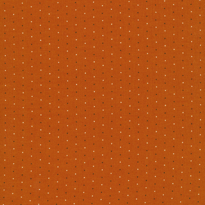 cream and black pin dots on a burnt orange background