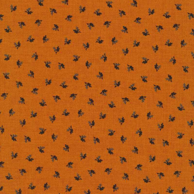 black and gray ditsy tossed leaves on a burnt orange background