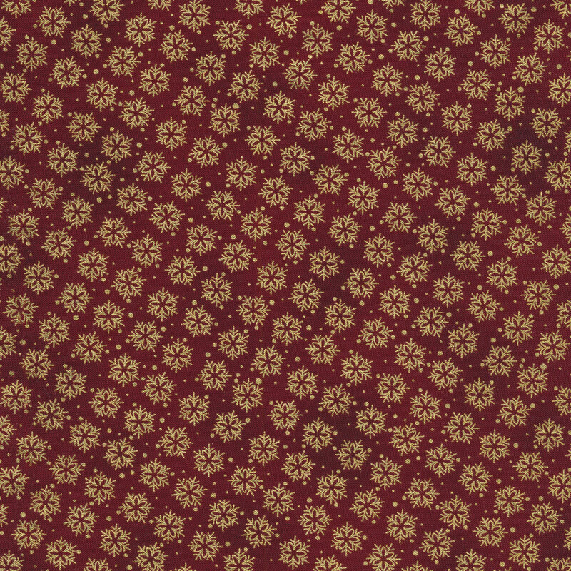 Red mottled fabric with gold metallic snowflakes all over