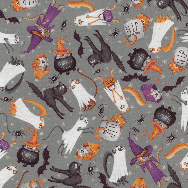 Gray fabric with tossed cats in costumes, tombstones, and cauldrons