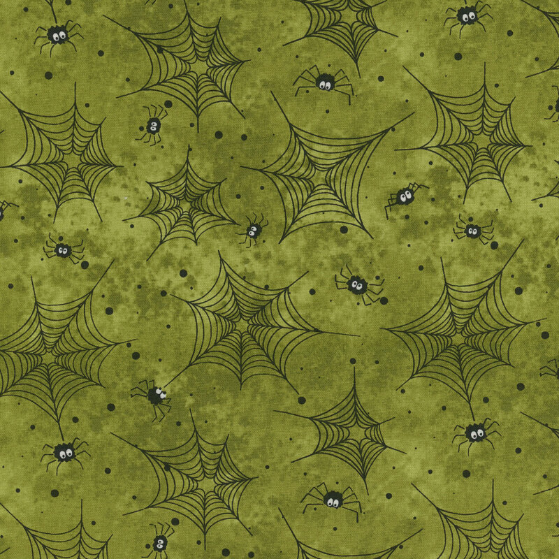 Green fabric with black spider webs, dots, and spiders all over