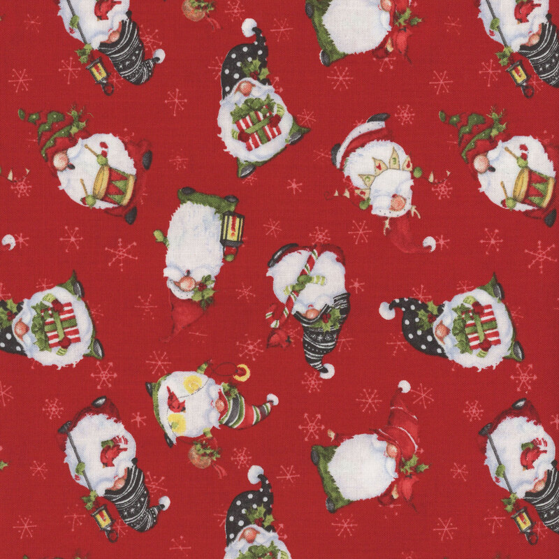 Red Christmas fabric with tossed winter gnomes and small white snowflakes all over