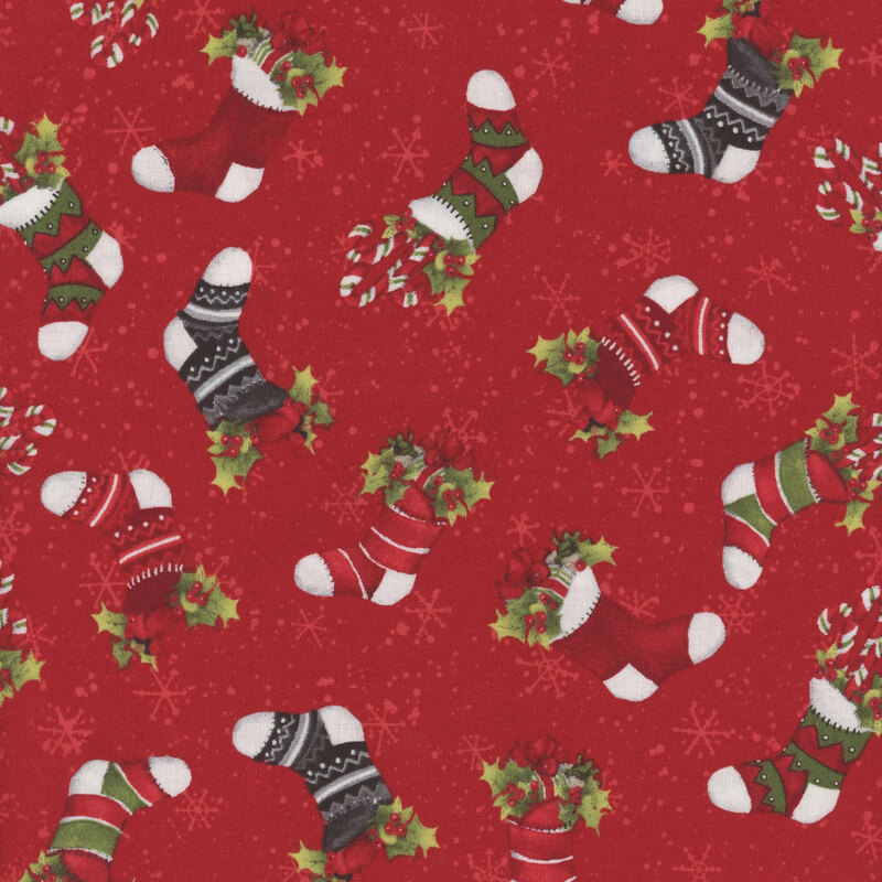 Red Christmas fabric with tossed Christmas stockings full of holly and presents all over