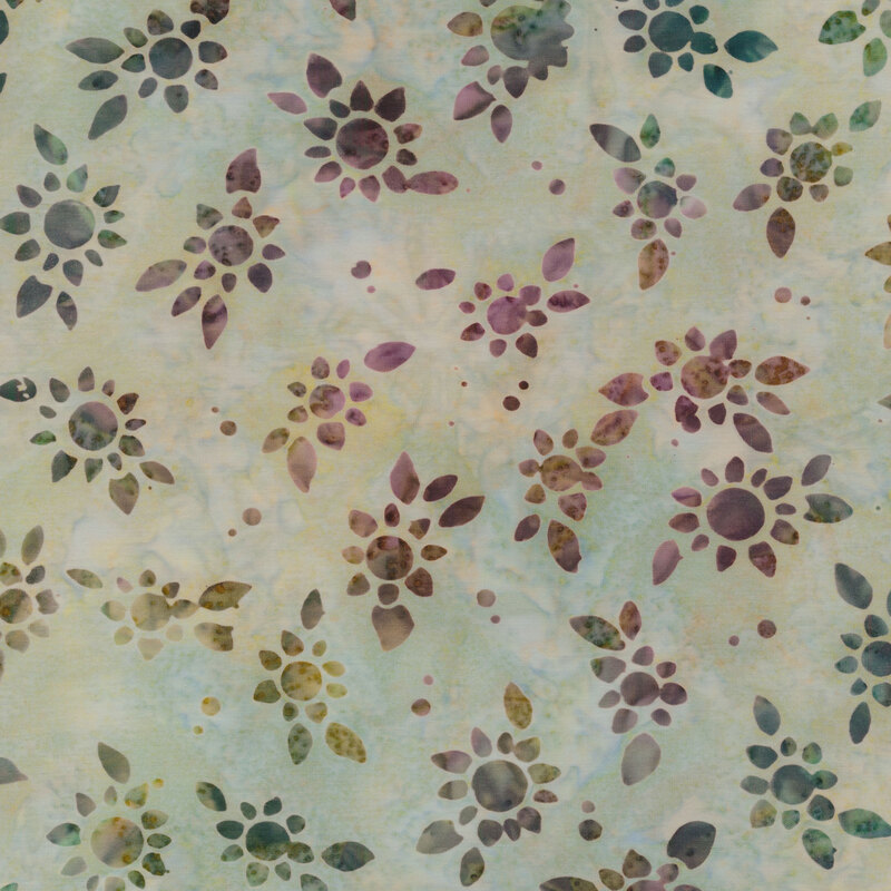 Mottled pale green fabric with tossed stencil images of sunflowers mottled with a rainbow of dark colors