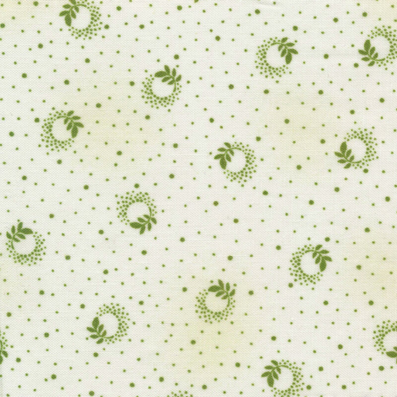 Scan of fabric featuring green ditzy spots on a white background with branch leaf designs