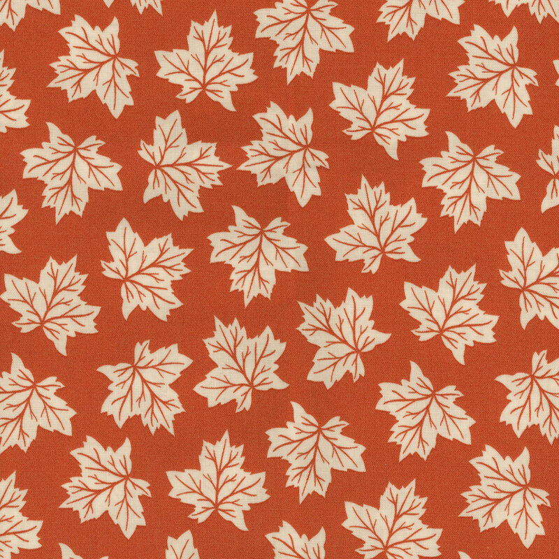 fabric featuring tossed off white maple leaves on a warm orange background