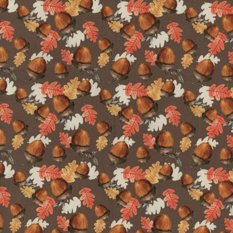 fabric featuring tossed acorns and orange, red, and white leaves on a brown background