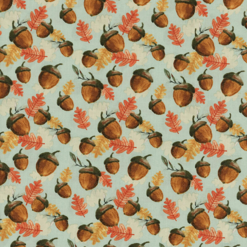 fabric featuring tossed acorns and orange, yellow, and white leaves on a light mint background