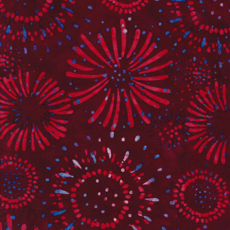 Dark red mottled fabric with red and blue fireworks all over