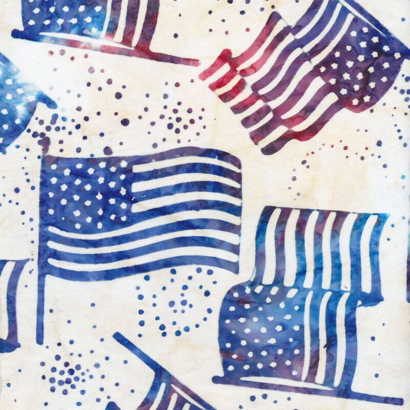 white fabric with red and blue mottled American flags and dots tossed in the foreground