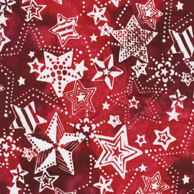 red mottled fabric with white stars in different styles and patterns all over