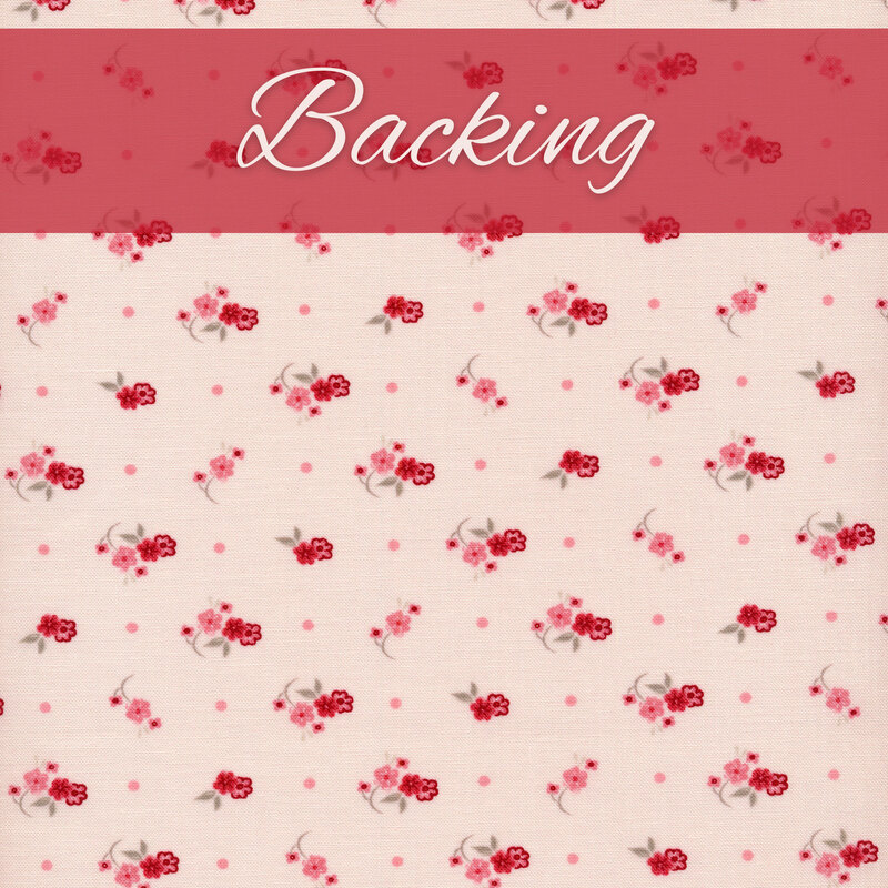 Pale pink fabric with small red and pink flowers clusters all over and a pink banner with the word 