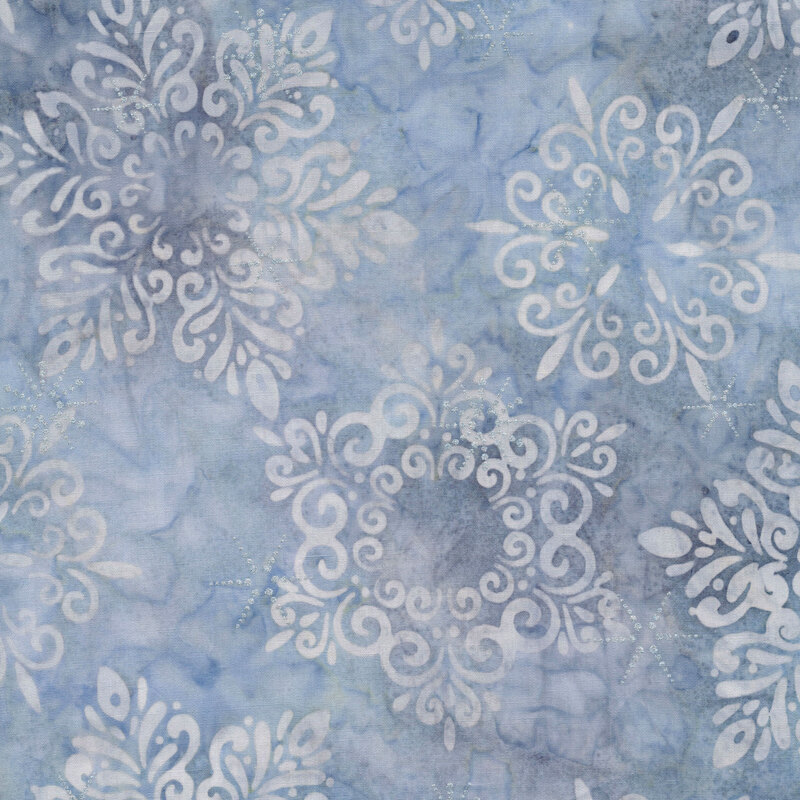 Pale blue marbled batik fabric with large white snowflakes and silver metallic accents