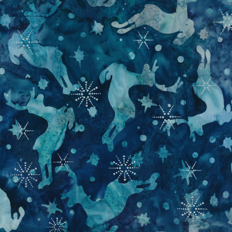 Navy blue marbled batik fabric with light blue jumping caribou and snowflakes with silver metallic accents