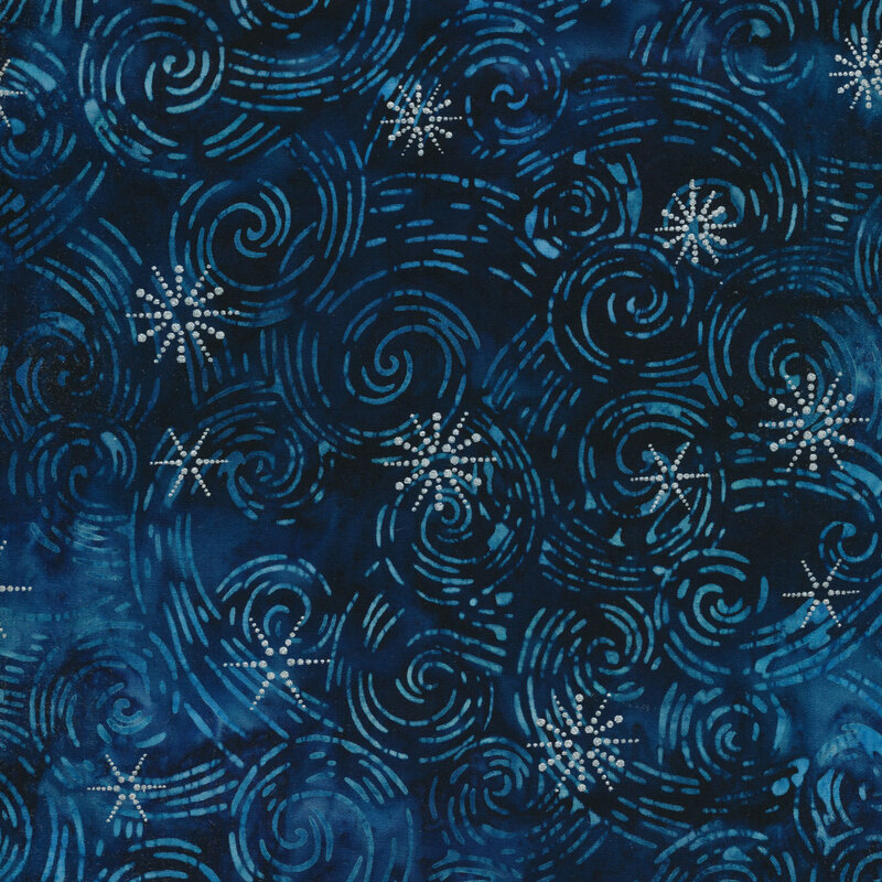 Dark blue mottled batik fabric with lighter blue tonal swirls all over and silver metallic accents