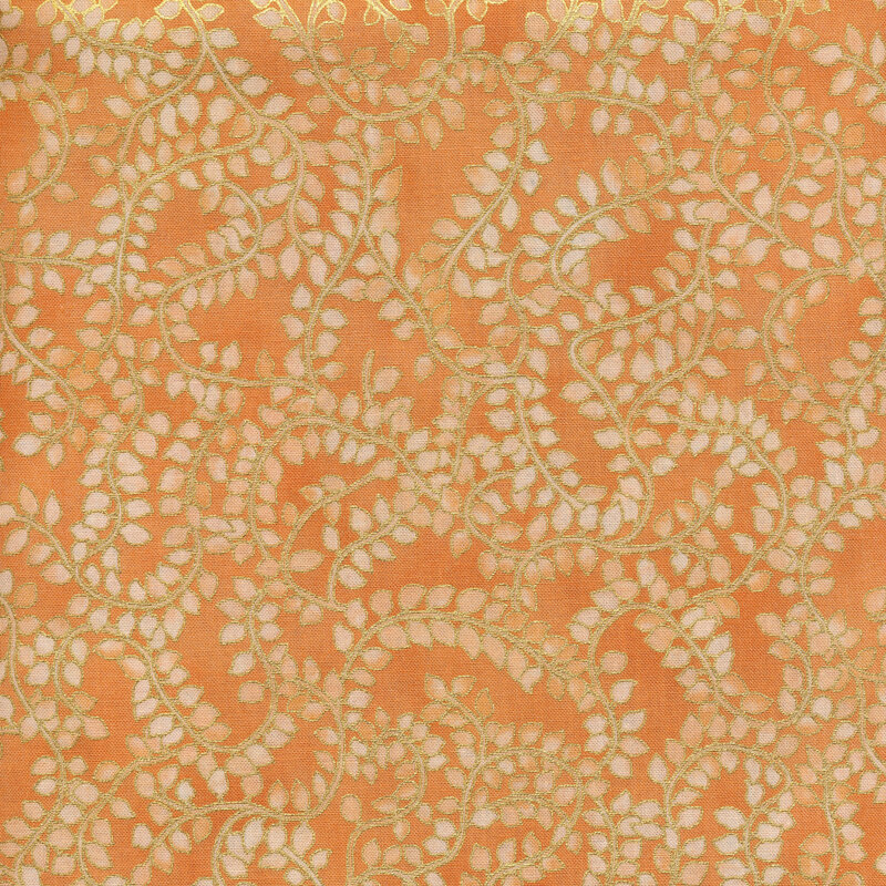 coral fabric with winding gold vines covered in small cream almond shaped leaves