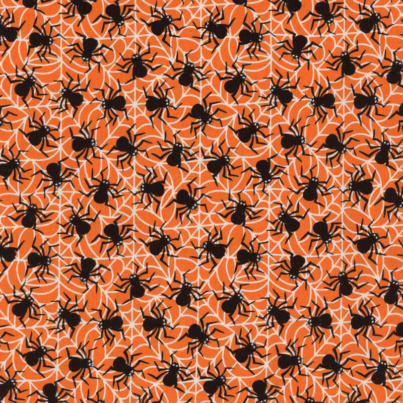 Bright orange fabric with white cobwebs and black spiders all over