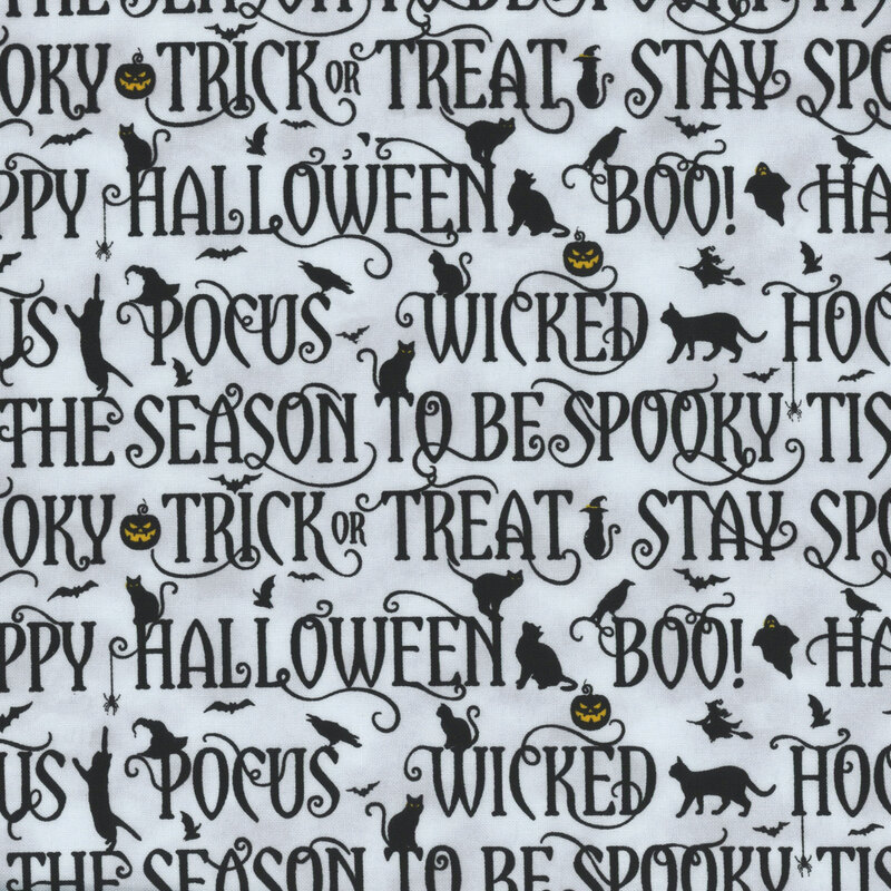 fabric featuring black halloween phrases on a cool gray background with metallic accents