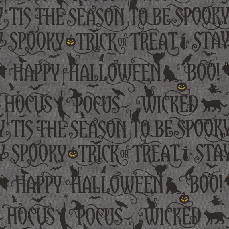 fabric featuring black halloween phrases on a dark gray background with cats, bats and jack-o-lanterns.