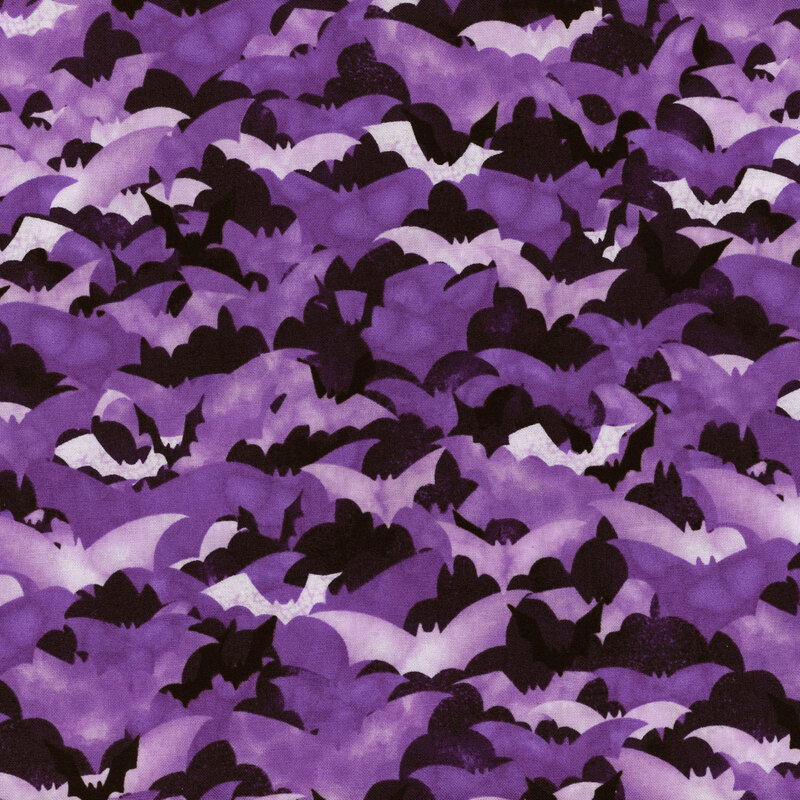 fabric featuring layered purple spooky bats on a dark purple background