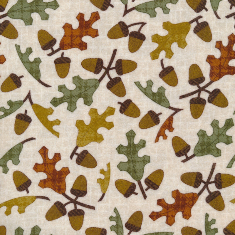 tossed acorns and fall leaves on a cream white background