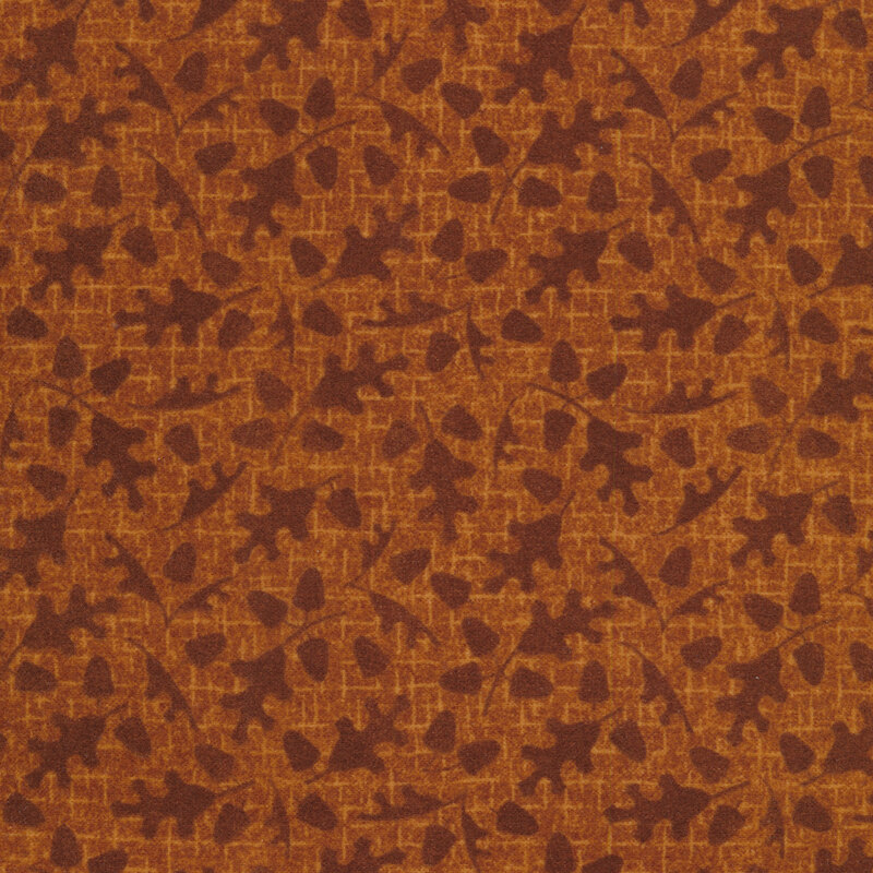 tonal burnt orange fabric with fall leaves and acorns on a burnt orange background