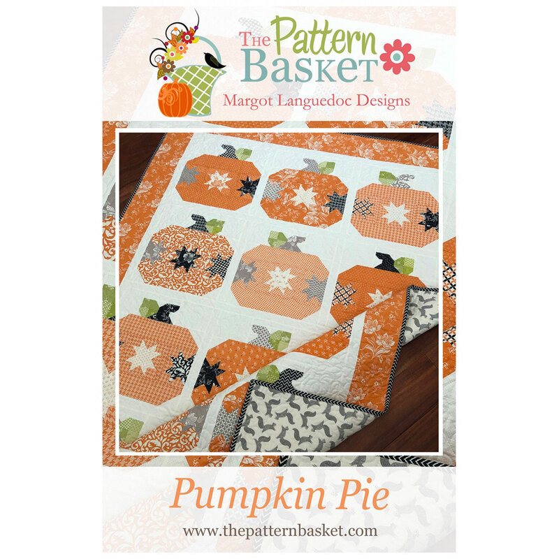 front of pattern booklet showing finished project quilt with orange pumpkins and orange border on a white background