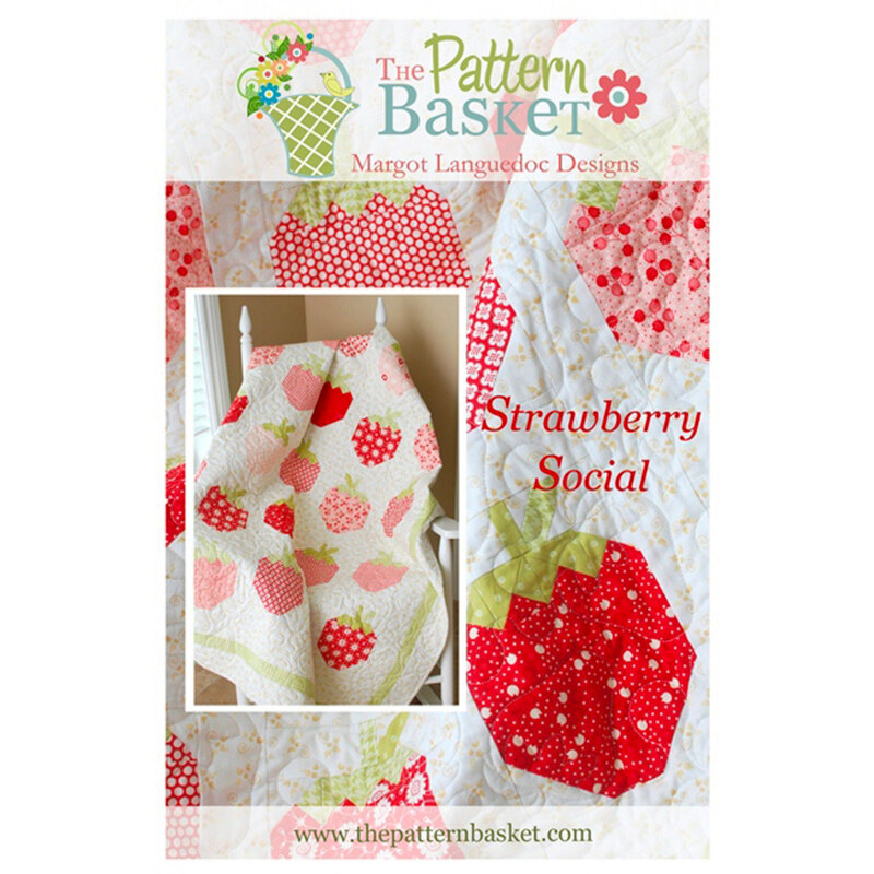 front of pattern booklet showing finished strawberry quilt draped over a white chair 