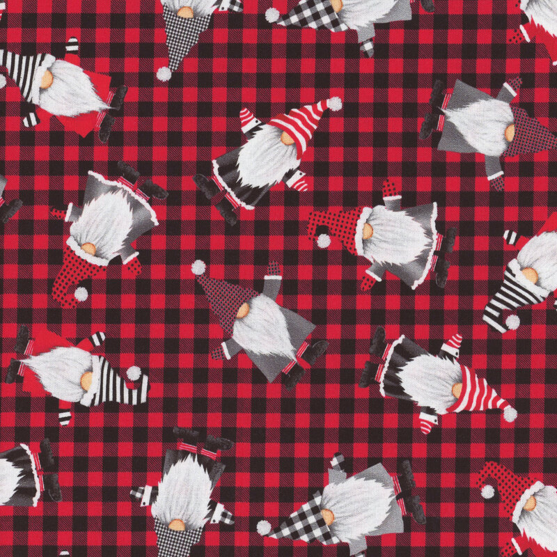 fabric featuring tossed gnomes on a red and black gingham background
