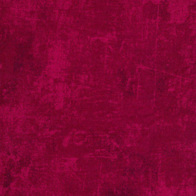 magenta fabric with a mottled design and tonal cracked canvas texture
